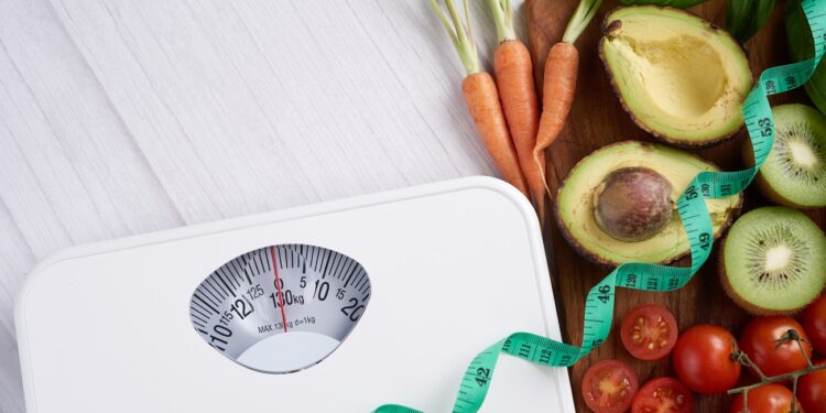 Weight loss scale with centimeter. Diet concept. Healthy food background. Food photography different fruits and vegetables. concept slimming diet fresh vegetables. top view.