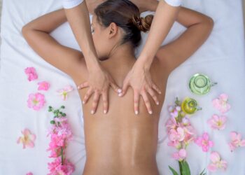 Beautiful Asian woman at the spa and relaxing with a back massage