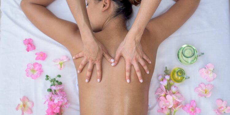 Beautiful Asian woman at the spa and relaxing with a back massage