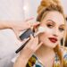 Preparing to party, carnival, celebration of attractive young women in beauty salon. Making makeup, stylish coiffure, professional stylist, cheerful mood, fashionable model