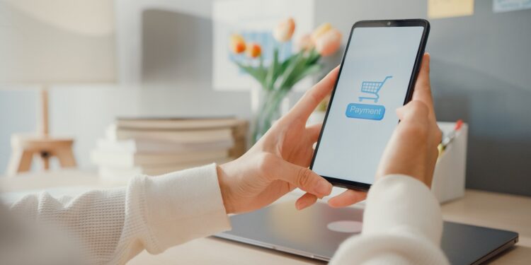 Young asia lady use cellphone order online shopping product and paying bills with banking app with transaction successful. Stay at house, Quarantine activity, Fun activity for coronavirus prevention.
