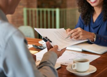 Businessman consulting with lawyer before signing contract