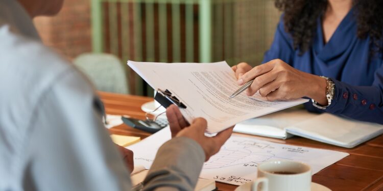 Businessman consulting with lawyer before signing contract