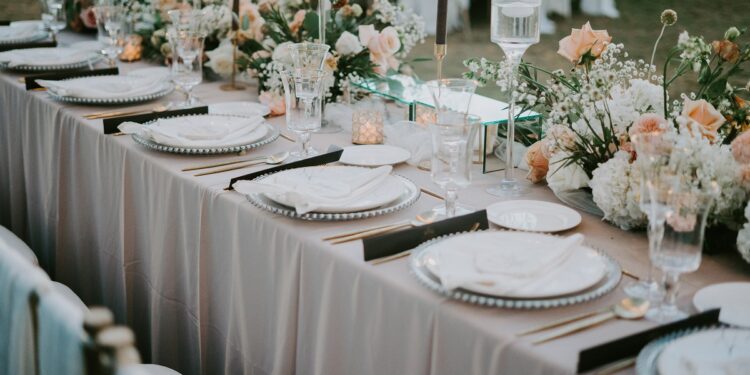 A decorated table setting with a floral design for a wedding celebration during daytime