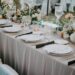 A decorated table setting with a floral design for a wedding celebration during daytime