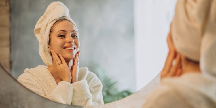 Woman at home applying cream mask