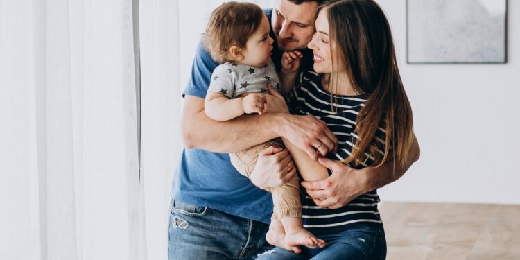 Young family with their little son at home