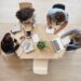 View from above. Business,startup, teamwork concept. Startup partners sitting at coworking space talking about future project, looking through examples of work on laptop and digital tablet