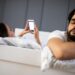 Couple problems. Husband is frustrated upset and unsatisfied while his internet addict wife is using mobile phone in social network