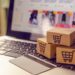 Shopping online concept - Shopping service on The online web. with payment by credit card and offers home delivery. parcel or Paper cartons with a shopping cart logo on a laptop keyboard