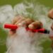 FILE PHOTO: A man uses a vape device in this illustration picture, September 19, 2019. REUTERS/Adnan Abidi/Illustration/File Photo