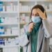Womam customer with headache at pharmacy