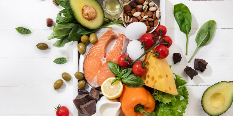 Ketogenic low carbs diet - food selection on white wooden background. Balanced healthy organic ingredients of high content of fats. Nutrition for the heart and blood vessels. Meat, fish and vegetables.
