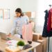 Young female entrepreneur running an online fashion business. Hispanic attractive woman preparing packages for customers' orders