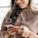 Smiling woman texting on her phone