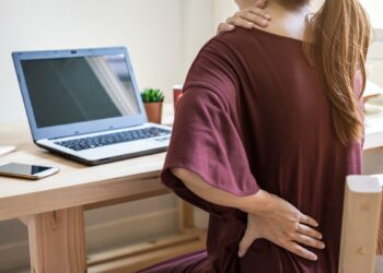 Young woman working at home and having back pain,  Healthcare and problem concept office syndrome