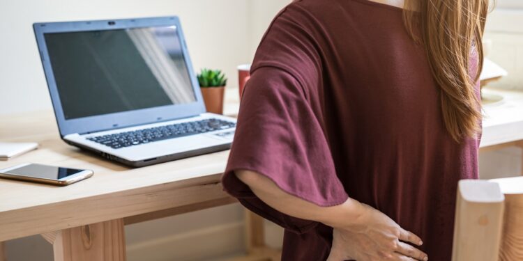 Young woman working at home and having back pain,  Healthcare and problem concept office syndrome
