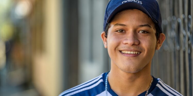 Jordy Virgilio Torres, 18, at home in San Pedro Sula, Honduras. 
When his uncle Alexander was killed by gangs and his grandfather died, Jordy Virgilio Torres, 12, at the time, was at risk of becoming a gang member. His mother, Melisica Torres, 39, says, "Jordy had every reason to join a gang. He was out of control when his grandpa died. When we lost grandpa, the only way we could get through this was with God's help." His mother introduced Jordy to church at Ministerio Siloe church, where Raul David Vasquez pastors. Now 18, Jordy, is an active youth leader and participates in World Vision Peace Clubs. World Vision has supported the church with hurricane relief, and also has Youth Ready and Parenting with Tenderness programs. See Kari Costanza story.