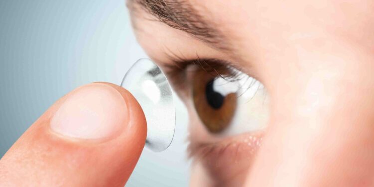 Man applying his contact lens