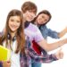 Row of teens with headphones showing thumbs up and smiling at camera