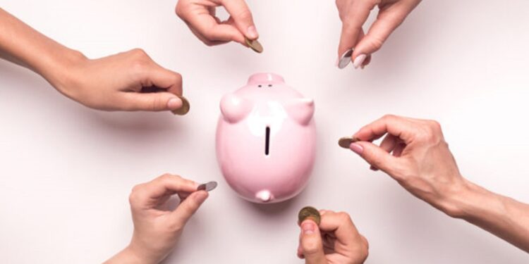 Togetherness concept. People hands throwing coins in piggy bank for crowdfunding, white background