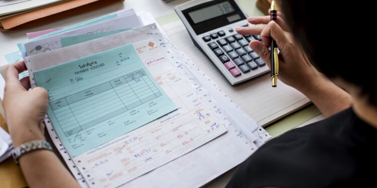 Asian woman working through paperwork