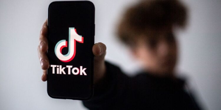 A teenager presents a smartphone with the logo of Chinese social network Tik Tok, on January 21, 2021 in Nantes, western France. (Photo by LOIC VENANCE / AFP) (Photo by LOIC VENANCE/AFP via Getty Images)