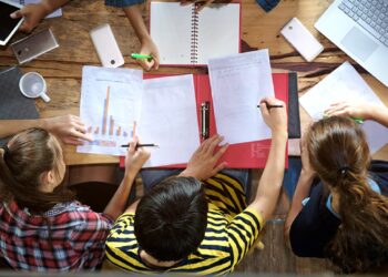 Top view of multiethnic diverse group of young college students brainstorm discussion about medical document and search data on laptop, co-working education teamwork concept; Shutterstock ID 729962209; Ordering Party: -
