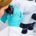 A scientist is utilizing a microscope, embodying the concepts of medical healthcare technology and pharmaceutical research and development.