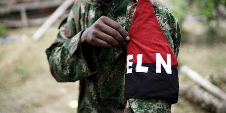 FILE PHOTO: A rebel of Colombia's Marxist National Liberation Army (ELN) shows his armband while posing for a photograph, in the northwestern jungles, Colombia August 31, 2017. REUTERS/Federico Rios/File Photo