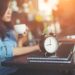 Beautiful hipster woman using laptop at cafe while drinking coffee.