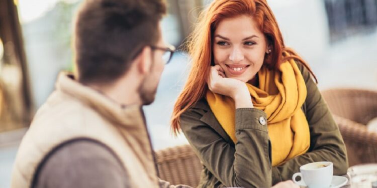 Attractive young couple in love sitting at the cafe table outdoors, drinking coffee; Shutterstock ID 2071229117; purchase_order: 061523; job: Editorial Associate; client: Ellie Spencer-Failes; other: