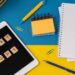 Work and study background with the help of a chatGPT bot. Words in wooden letters. Table top view with open notebook copy space. Chat GPT for working and creating