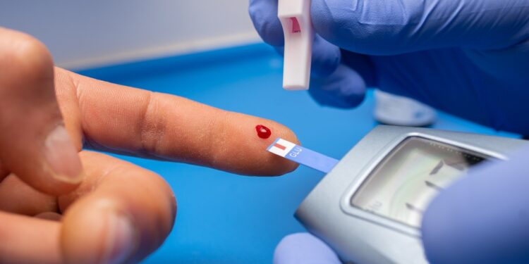 A closeup shot of a doctor with rubber gloves taking a blood test from a patient
