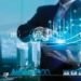 Digital marketing. Business strategy. Businessman using tablet analyzing sales data and economic growth graph chart on hologram screen. Business strategy and digital data.