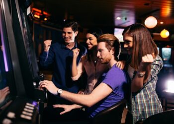 Young people at slot machine in the casino