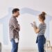 Couple painting the interior wall in their new apartment