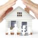 holding house representing home ownership