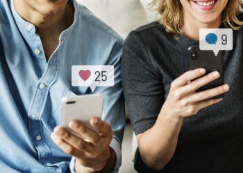 Happy people using social media on their smartphones