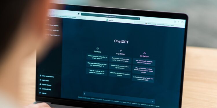 Close view of a man with opened AI chat on laptop
