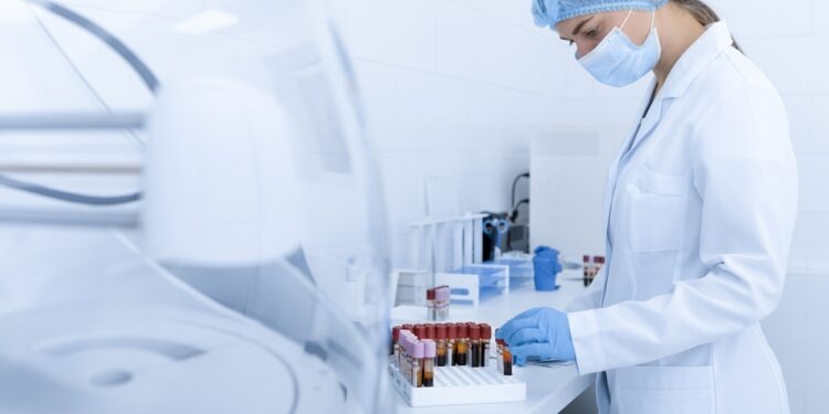 Woman collecting blood samples for testing on different diseases, modern laboratory, copy space