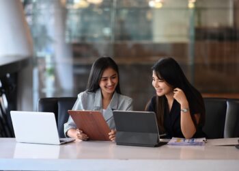 Two young businesswoman discussing new creative concept for the new product marketing promotion.