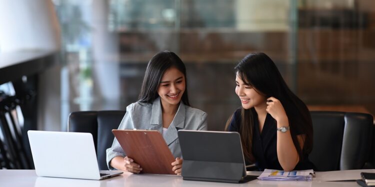 Two young businesswoman discussing new creative concept for the new product marketing promotion.