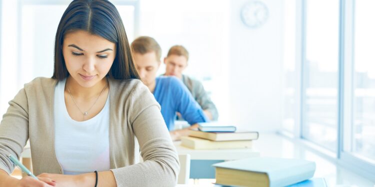 Portrait of pensive student carrying out test at lesson