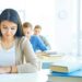 Portrait of pensive student carrying out test at lesson