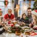 Happy multi-generation family talking while having New Year's meal at dining table.