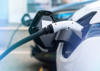 Plugged in chargers into two electric cars at charge station