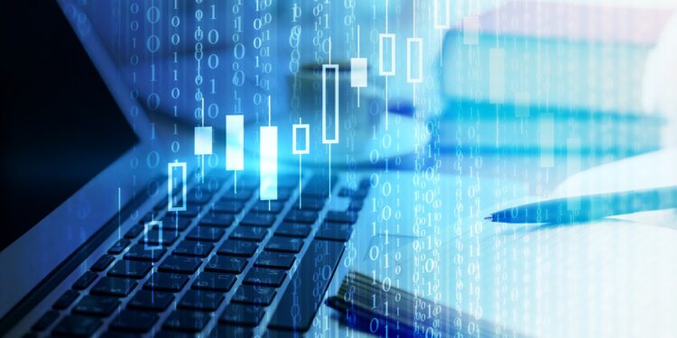 Close up of office desktop with laptop, abstract forex chart, coffee cup and other items. Finance and computing concept. Double exposure