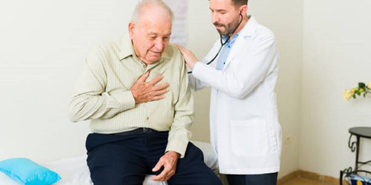 Caucasian old man feeling sick with heart problems coming into the doctor's office for a medical exam