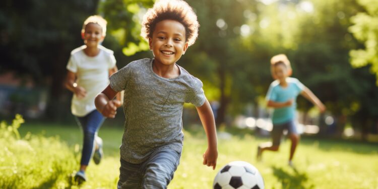 children playing football in a park.